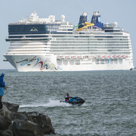 Hundreds watch as the Norwegian Epic cruise ship returns to Port Canaveral in 2019.