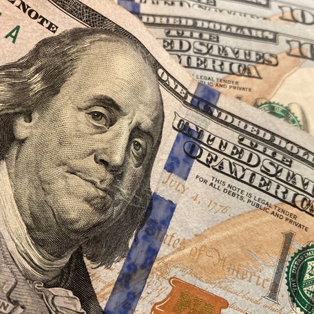 A stock image of multiple $100 bills.