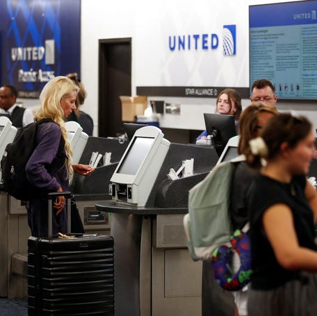An airline passenger checks in at the United ticket counters at Tampa International Airport in Tampa, Florida, U.S., July 19, 2024. REUTERS/Octavio Jones