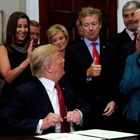 Senator Rand Paul (R-KY) gives U.S. President Donald Trump a thumbs up after Trump signed an Executive Order to make it easier for Americans to buy bare-bone health insurance plans and circumvent Obamacare rules at the White House in Washington, U.S., October 12, 2017.