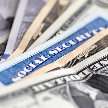 Social security card with US currency. Retirement benefit concept