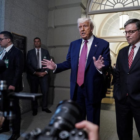 U.S. President Donald Trump gestures next to U.S. House Speaker Mike Johnson (R-LA), on the day of a closed House Republican Conference meeting on Capitol Hill in Washington, D.C., U.S., May 20, 2025.
