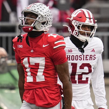 Ohio State Buckeyes wide receiver Carnell Tate (17) celebrates a first down catch beside Indiana Hoosiers defensive back Terry Jones Jr. (12) during the NCAA football game at Ohio Stadium in Columbus on Monday, Nov. 25, 2024.
