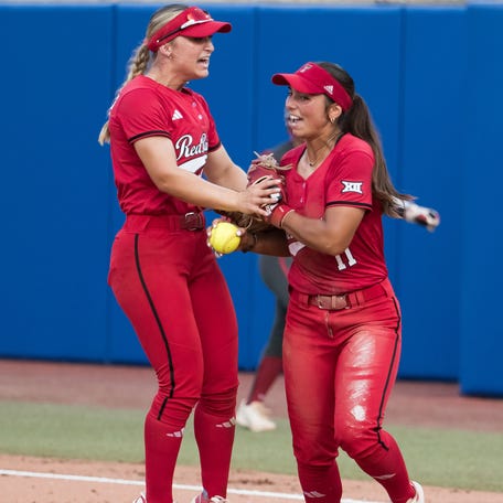 Texas Tech infielders Alexa Langeliers (23) celebrates an out \with Lauren Allred (11) during their Women's College World Series semifinal game against Oklahoma at Devon Park.