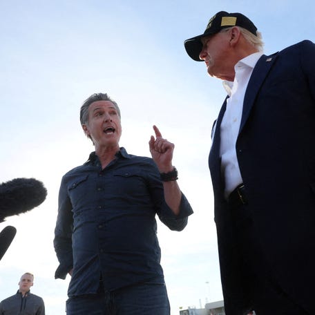 Governor of California Gavin Newsom speaks next to U.S. President Donald Trump upon Trump's arrival to tour areas impacted or destroyed by the southern California wildfires, at Los Angeles International Airport in Los Angeles, California, U.S., January 24, 2025.