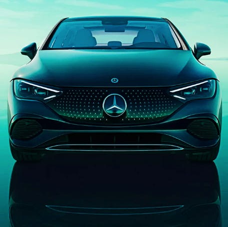 A black Mercedes-Benz EQE electric sedan is parked.
