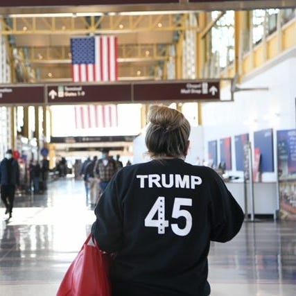 A Trump supporter walks in the B Terminal of Ronald Reagan Washington National Airport on Jan. 7, 2021.