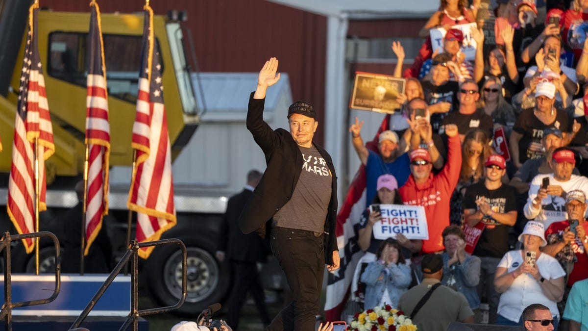 Elon Musk joins former President Donald Trump on stage as Trump speaks at a campaign rally in Butler, Pa., on October 5, 2024.