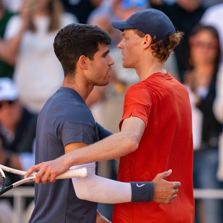 Carlos Alcaraz, left, and Jannik Sinner embrace after their match at the 2024 French Open on June 7, 2024 in Paris.
