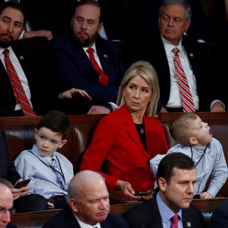 Rep. Mary Miller, R-IL, sits among House colleagues with two of her 17 grandchildren while watching and listening to the vote for a new Speaker of the House on January 3, 2023.