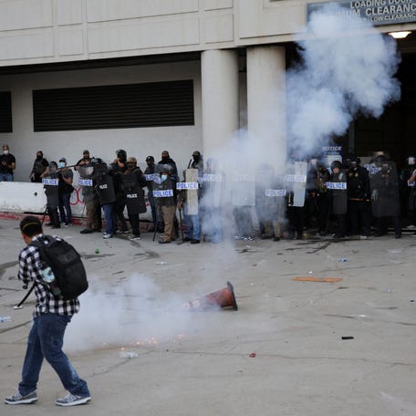 Riot police use stun grenades as protesters gather around the Los Angeles Federal Building following multiple detentions by Immigration and Customs Enforcement (ICE), in downtown Los Angeles, California, U.S., June 6, 2025. REUTERS/Daniel Cole