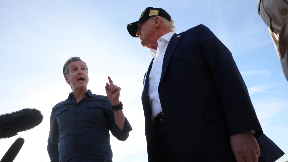 Governor of California Gavin Newsom speaks next to U.S. President Donald Trump upon Trump's arrival to tour areas impacted or destroyed by the southern California wildfires, at Los Angeles International Airport in Los Angeles, California, U.S., January 24, 2025. REUTERS/Leah Millis