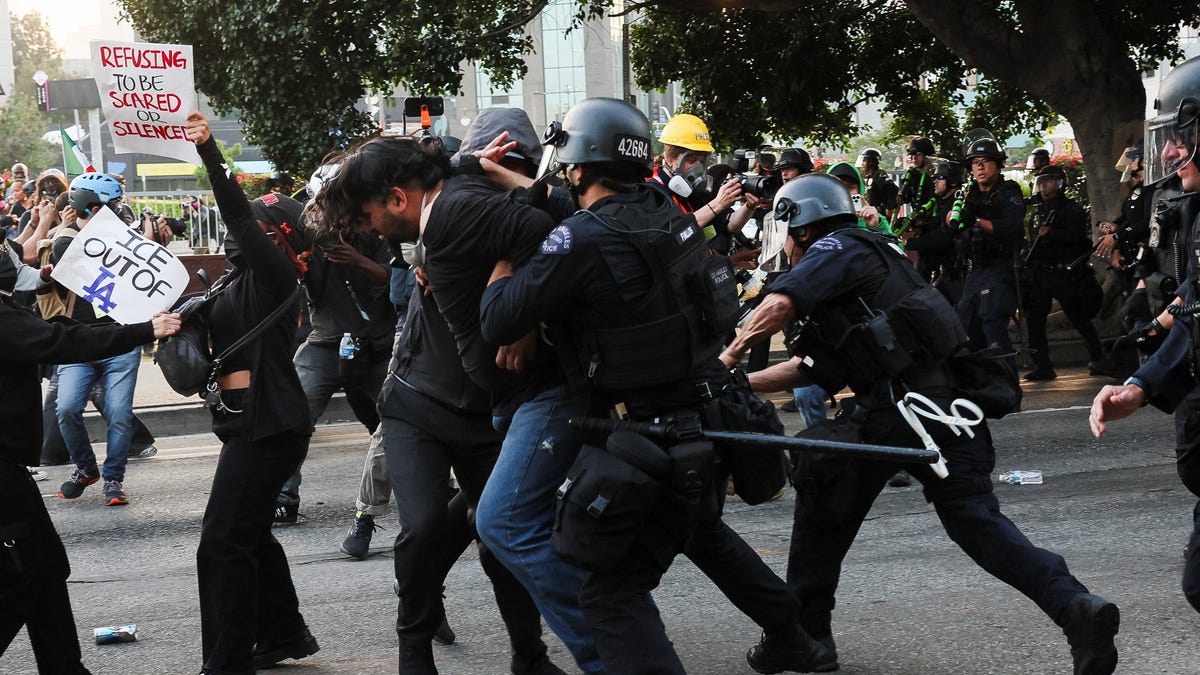 Police officers detain a demonstrator, during protests against federal immigration sweeps, in Los Angeles, California on June 9, 2025.