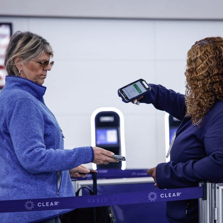 A woman has her identification checked at a Transportation Security Administration (TSA) checkpoint during the first day of Real ID requirements for those flying within the United States, at Newark Liberty International Airport in Newark, New Jersey on May 7, 2025. Real ID is a security-enhanced form of identification that meets federal standards established by the Real ID Act passed by Congress in 2005, following recommendations from the 9/11 Commission. (Photo by kena betancur / AFP) (Photo by   KENA BETANCUR/AFP via Getty Images)