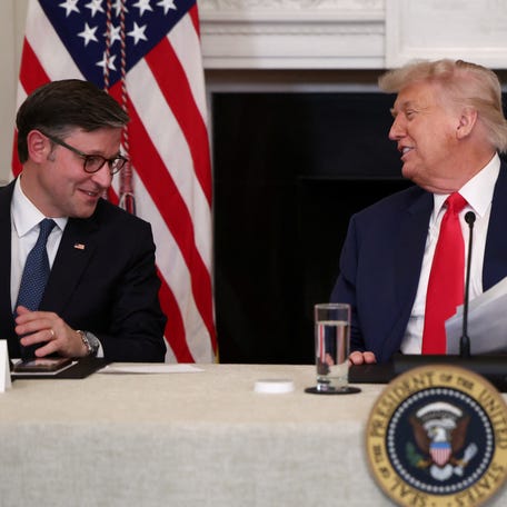 U.S. President Donald Trump and U.S. House Speaker Mike Johnson react during an Invest America Roundtable in the State Dining room, at the White House, in Washington, U.S., June 9, 2025.