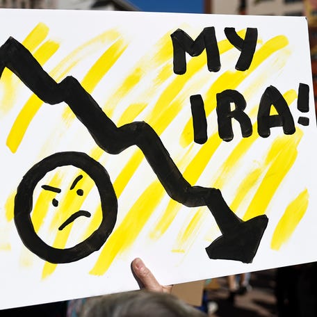 LOS ANGELES, CALIFORNIA - APRIL 05: A person holds a sign reading 'My IRA!' as protestors prepare to march in a 'Hands Off!' protest against the Trump administration on April 5, 2025 in Los Angeles, California. Protests against Trump administration policies and Elon Musk's Department of Government Efficiency (DOGE) are being held nationwide in what organizers are calling a National Day of Action. (Photo by Mario Tama/Getty Images)