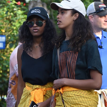 Sasha Obama (left) and Malia Obama, daughters of podcast host Michelle Obama and former president Barack Obama, visit Tirtha Empul temple at Tampaksiring Village in Gianyar on the Indonesian resort island of Bali on June 27, 2017.