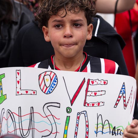 The 11-year-old cousin of a Milford High junior who was detained by ICE on Saturday, stands with a sign during a protest in front of Milford Town Hall on Main Street, June 1, 2025.
