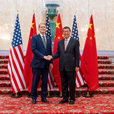 US Secretary of Treasury Scott Bessent and Chinese Vice Premier He Lifeng shake hands as they pose for a photo during trade discussions at the Lancaster House in London on June 9, 2025.