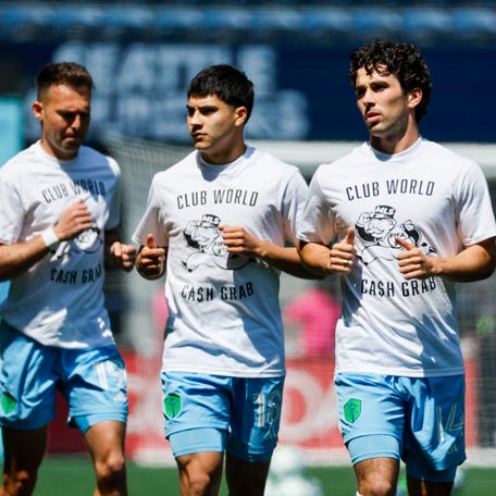 Jun 1, 2025; Seattle, Washington, USA; Seattle Sounders FC forward Danny Musovski (19), midfielder Obed Vargas (18) and midfielder Paul Rothrock (14) wear t-shirts to protest FIFA Club World Cup bonus sharing from MLS while participating in pregame warmups