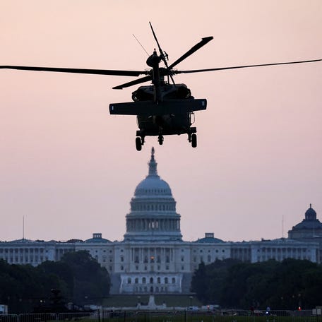 A military helicopter, to be used in the U.S. Army's 250th birthday celebration and parade in Washington, DC, on June 14, 2025, prepares to land on the National Mall three days ahead.