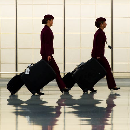 Two flight attendants walk in the luggage claim area of the US Customs and Immigration at Dulles International Airport (IAD) on December 21, 2011.