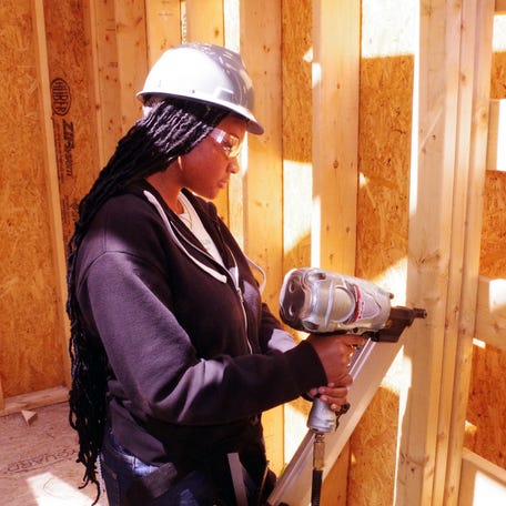 Keara Searcy, 16 of Brockton, and a student at Southeastern Regional Technical High School in Easton, uses a nail gun to fix wooden beams inside the structure of what will become the new Welcome Center at DW Field Park, on Monday, May 12, 2025, as construction continues.
