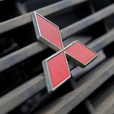 A Mitsubishi logo is seen on a hood mask.