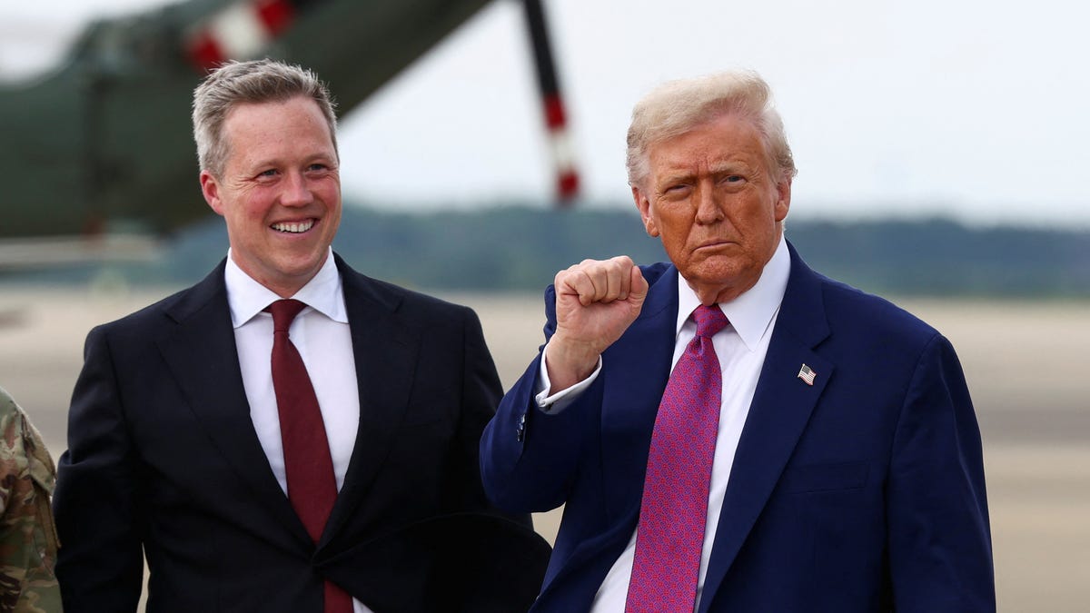 President Donald Trump pumps a fist next to U.S. Army Secretary Daniel Driscoll, upon arrival at Pope Army Airfield, North Carolina, U.S., June 10, 2025.