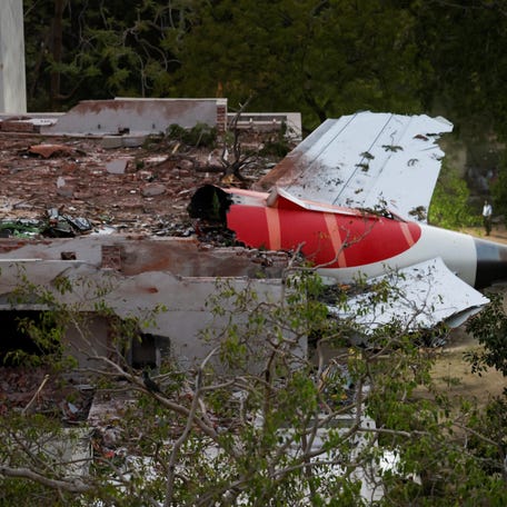 A tail of an Air India Boeing 787 Dreamliner plane that crashed is seen stuck on a building after the incident in Ahmedabad, India on June 12, 2025.
