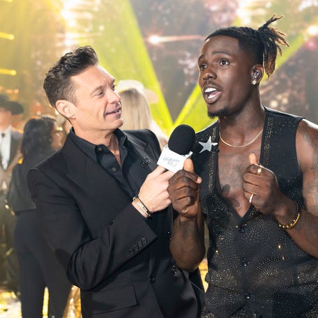 Ryan Seacrest and Jamal Roberts (right) on the Season 23 finale of "American Idol."