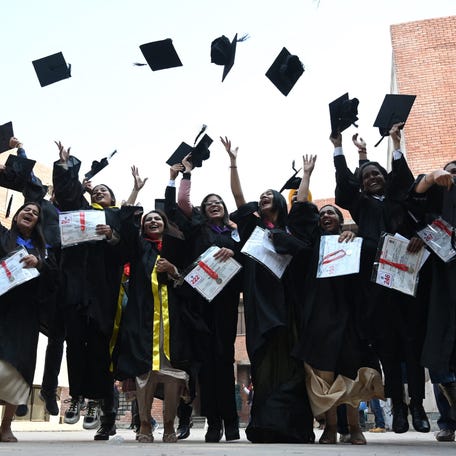 Students throw their graduation hats in the air during the 48th annual convocation at Guru Nanak Dev university in Amritsar on Nov. 25, 2022.
