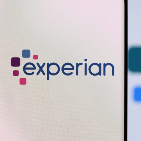 Experian logo is seen on a smartphone in front of displayed same logo in this illustration taken, December 1, 2021.