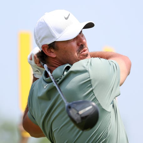 Brooks Koepka plays his shot from the ninth tee during the first round of the U.S. Open golf tournament.