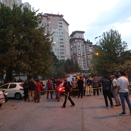 People gather in the street in the aftermath of Israeli strikes, in Tehran, Iran on June 13, 2025.