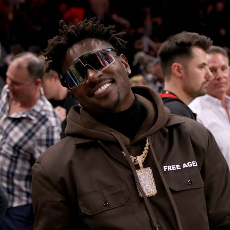 Mar 11, 2022; Atlanta, Georgia, USA; Former Tampa Bay Buccaneers wide receiver Antonio Brown poses for photographers after the game between the Atlanta Hawks and the LA Clippers at State Farm Arena. Mandatory Credit: Jason Getz-USA TODAY Sports