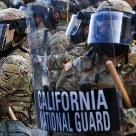 National Guard troops are pictured wearing gas masks during protests against federal immigration sweeps in Los Angeles.