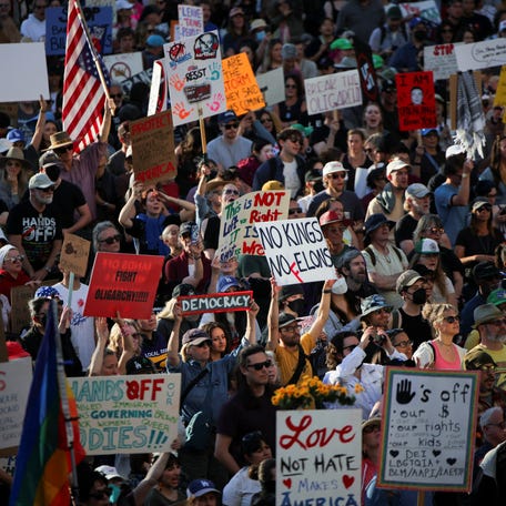 Demonstrators hit the streets in Los Angeles on April 5, 2025, to protest President Donald Trump and his advisor Elon Musk.