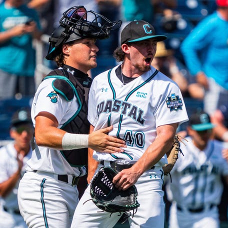 Coastal Carolina Chanticleers pitcher Dominick Carbone (40) and catcher Caden Bodine (17) celebrate after defeating the Arizona Wildcats.