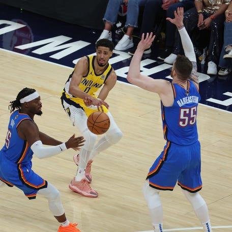 Indiana Pacers guard Tyrese Haliburton (0) passes past Oklahoma City Thunder guard Luguentz Dort (5) and center Isaiah Hartenstein (55) during the second quarter of game four of the 2025 NBA Finals at Gainbridge Fieldhouse in Indianapolis, Indiana on June 13, 2025.