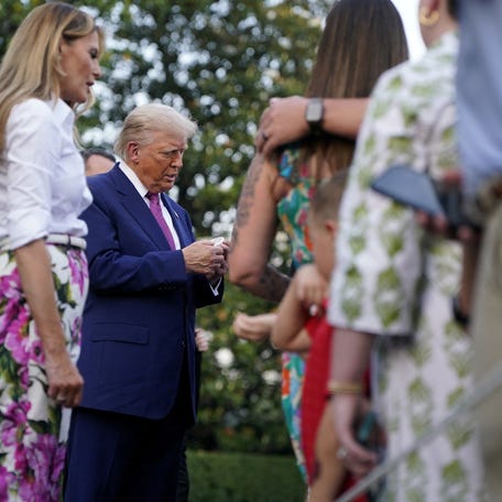 Donald Trump and Melania Trump greet attendees during the congressional picnic at the White House in Washington, D.C. on June 12, 2025.