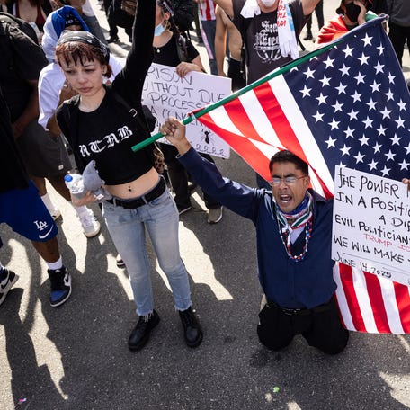 A demonstrator reacts during clashes that erupted after authorities declared an unlawful assembly during the "No Kings" protest against the Trump administration in Los Angeles on June 14, 2025 on the day of Trump's military parade in Washington, DC. Tens of thousands of protesters rallied nationwide Saturday against Donald Trump ahead of a huge military parade on the US president's 79th birthday -- as the killing of a Democratic lawmaker underscored the deep divisions in   American politics. "No Kings" demonstrators took to the streets in New York, Los Angeles, Chicago, Philadelphia, Houston, Atlanta and hundreds of other cities across the United States to condemn what they call Trump's dictatorial overreach.