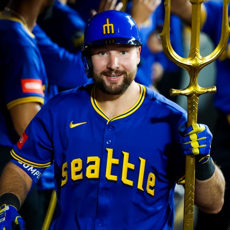 Cal Raleigh celebrates a home run against the Twins.