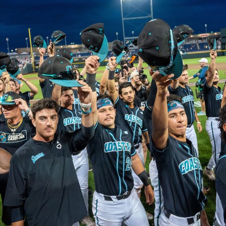 June 15: The Coastal Carolina Chanticleers tip their hats to fans after a 6-2 win against Oregon State.