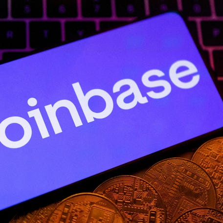 Smartphone with displayed Coinbase logo and representation of cryptocurrencies are placed on a keyboard in this illustration taken, June 8, 2023.