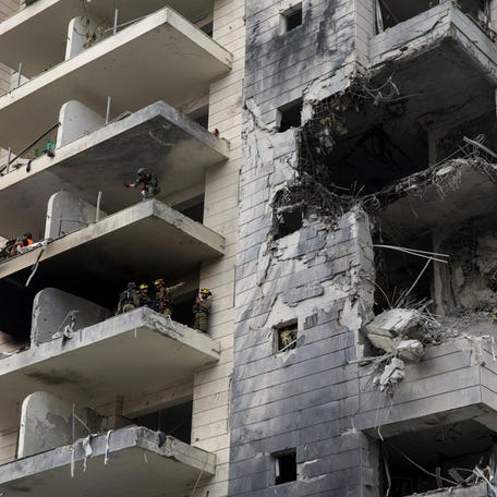 Rescue and security personnel work inside an impacted residential building following missile attack from Iran on Israel, central Israel June 16, 2025.