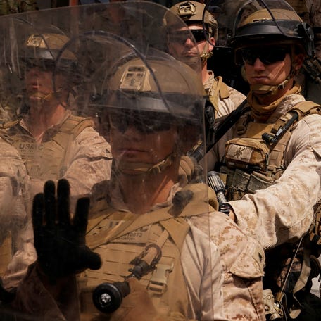 U.S. Marines stand guard as people protest against President Donald Trump's policies and federal immigration sweeps during a No Kings Day demonstration in Los Angeles, California, U.S., June 14, 2025.