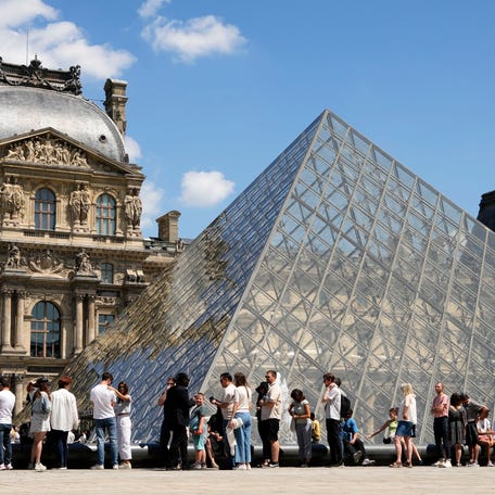 Visitors wait for their timed entry into the Louvre Museum in Paris, France on Jul 17, 2024.