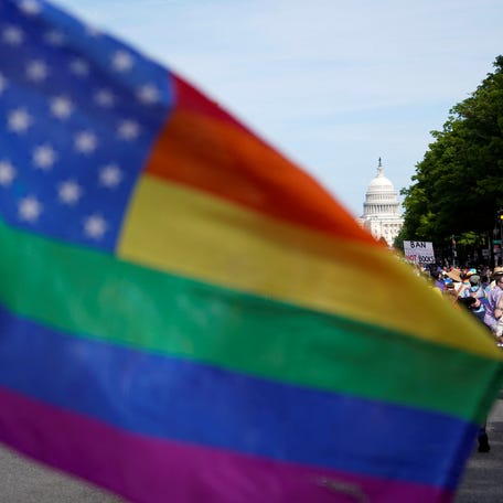A flag waves as people take part in the annual LGBTQ+ Capital Pride parade in Washington on June 8, 2024.
