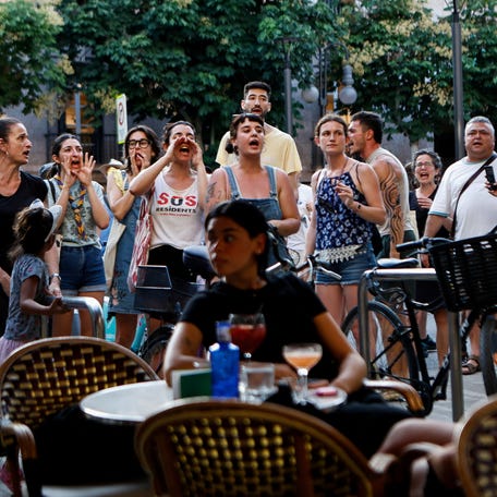 Protesters shout anti-tourism slogans at tourists sitting at a bar, in Palma de Mallorca, Spain, June 15, 2025.